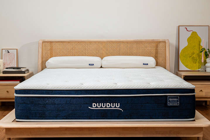 Mattress with 'DUUDUU' branding on a wooden bed frame in a bedroom setting.